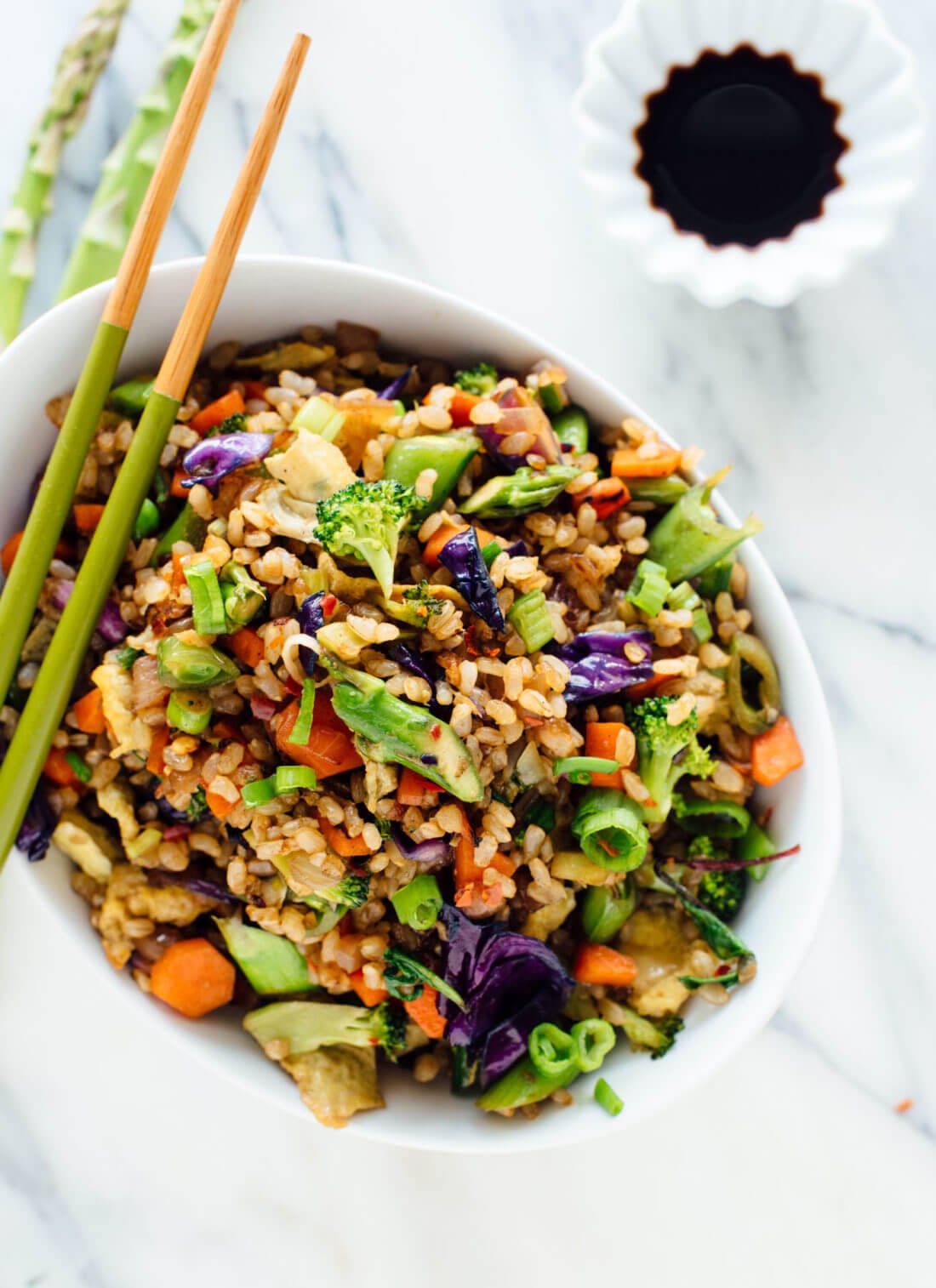 Vegetable fried rice made with extra veggies and brown rice, for health and flavor bonus points! Get the recipe at cookieandkate.com