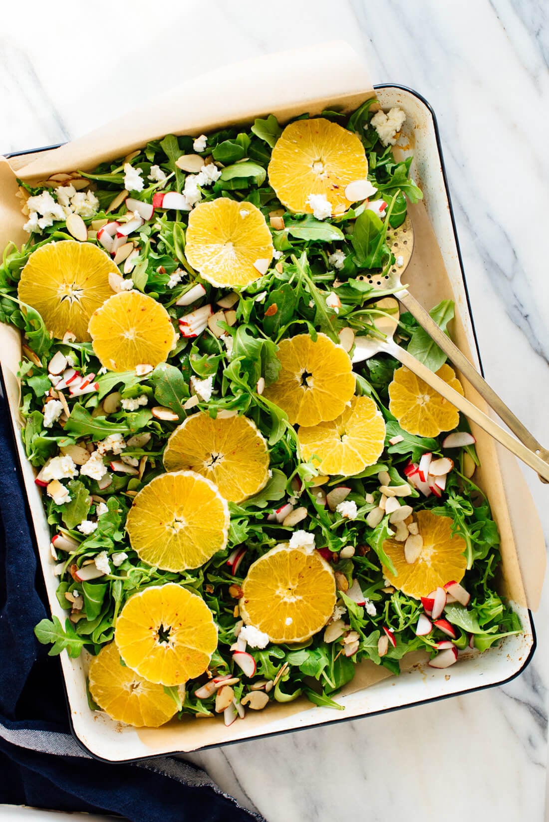 orange arugula salad with goat cheese, almonds and radishes